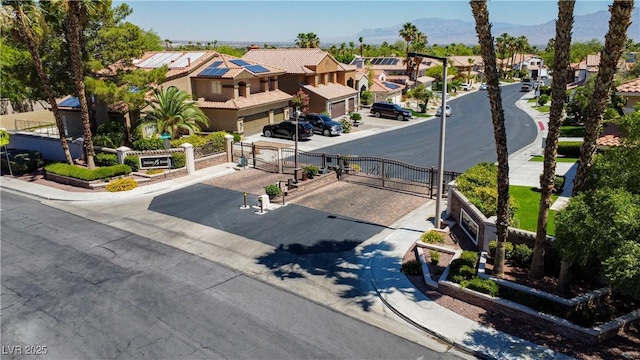 2208 Fiero Dr, Las Vegas, NV 89134 - view of asphalt street featuring a residential view, a gate, and sidewalks