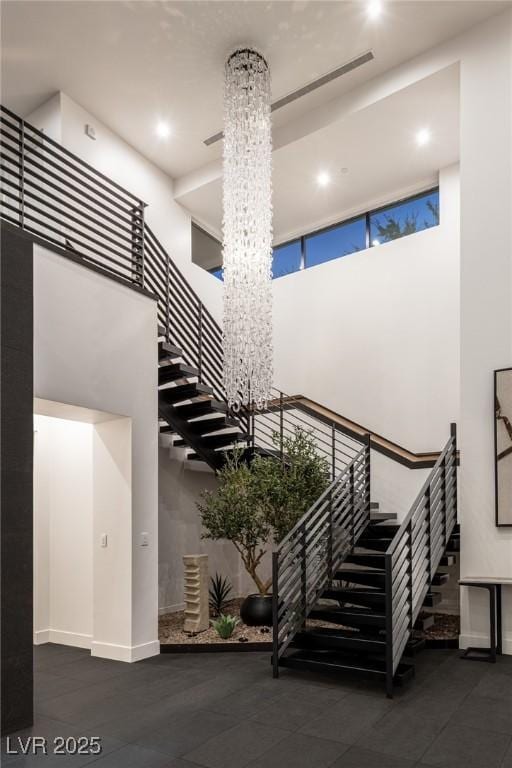 1491 Reims Dr, Henderson, NV 89012 - stairway with a high ceiling, a chandelier, and recessed lighting