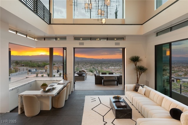 1491 Reims Dr, Henderson, NV 89012 - living room with a high ceiling, healthy amount of natural light, and a chandelier