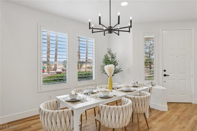 9900 Summer Ash Ct Unit 103, Las Vegas, NV 89134 - dining space with a chandelier and light wood-style flooring