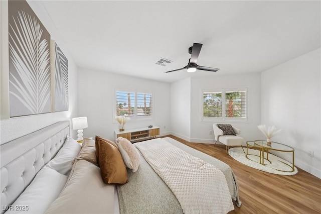 9900 Summer Ash Ct Unit 103, Las Vegas, NV 89134 - bedroom with multiple windows, wood finished floors, and ceiling fan