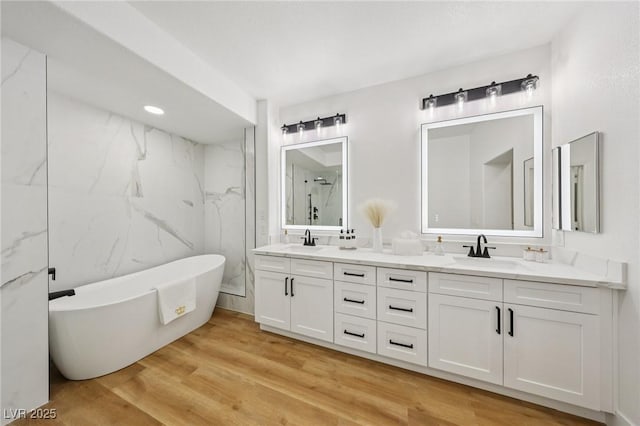 9900 Summer Ash Ct Unit 103, Las Vegas, NV 89134 - full bath featuring double vanity, a freestanding bath, and wood finished floors