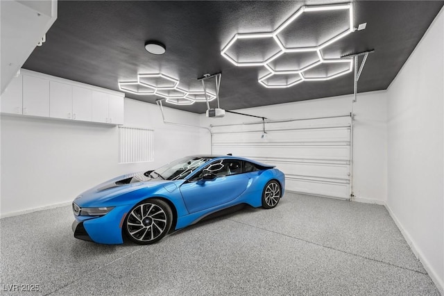 9900 Summer Ash Ct Unit 103, Las Vegas, NV 89134 - garage featuring a garage door opener and baseboards