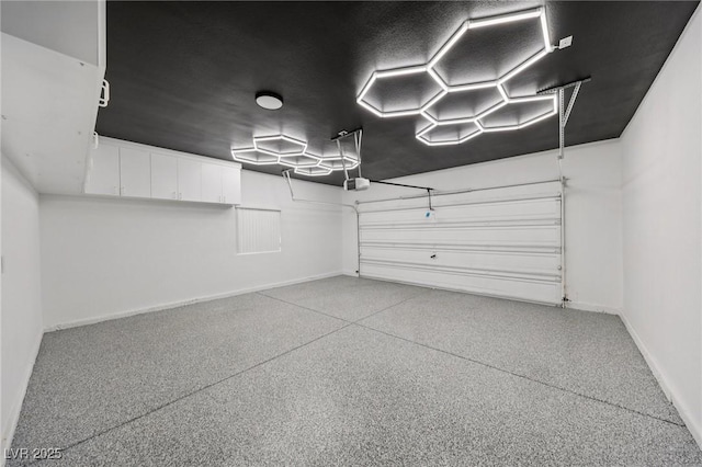 9900 Summer Ash Ct Unit 103, Las Vegas, NV 89134 - garage with baseboards and a garage door opener