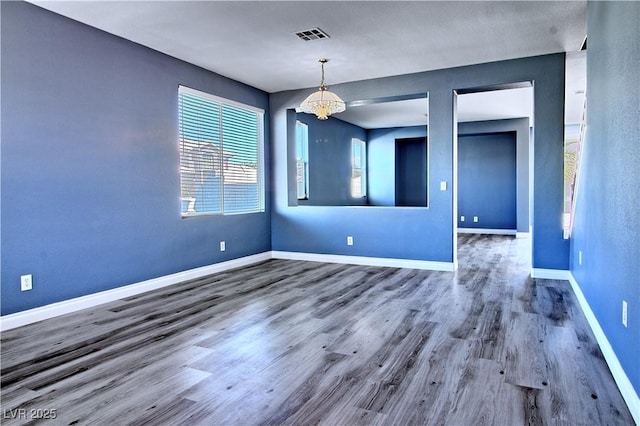 6042 Thorne Bay Ct, Las Vegas, NV 89110 - empty room with wood finished floors and a chandelier
