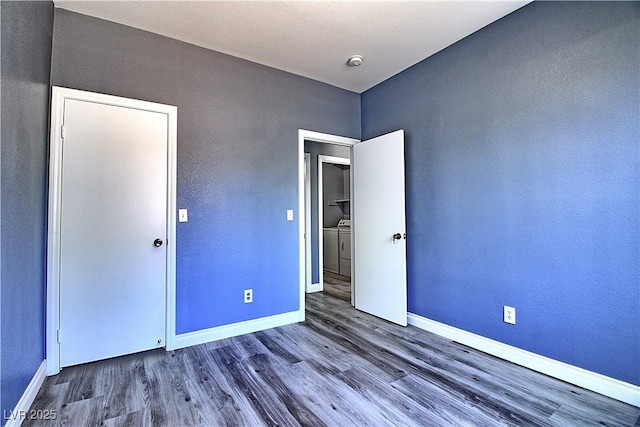 6042 Thorne Bay Ct, Las Vegas, NV 89110 - unfurnished bedroom with wood finished floors and independent washer and dryer