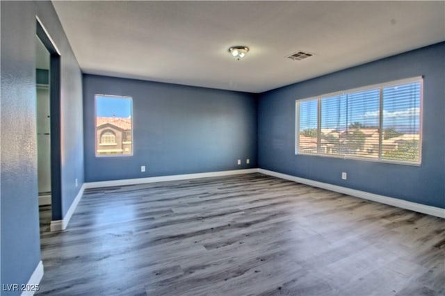 6042 Thorne Bay Ct, Las Vegas, NV 89110 - spare room featuring wood finished floors and a baseboard radiator