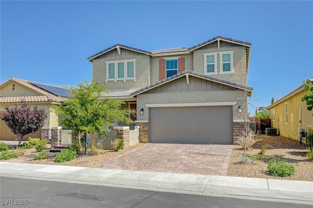 2940 Duverney Ave, Henderson, NV 89044 - craftsman house with stone siding, decorative driveway, stucco siding, and an attached garage