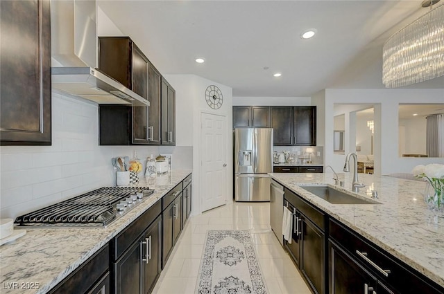 2940 Duverney Ave, Henderson, NV 89044 - kitchen with appliances with stainless steel finishes, wall chimney exhaust hood, decorative backsplash, light stone countertops, and dark brown cabinetry