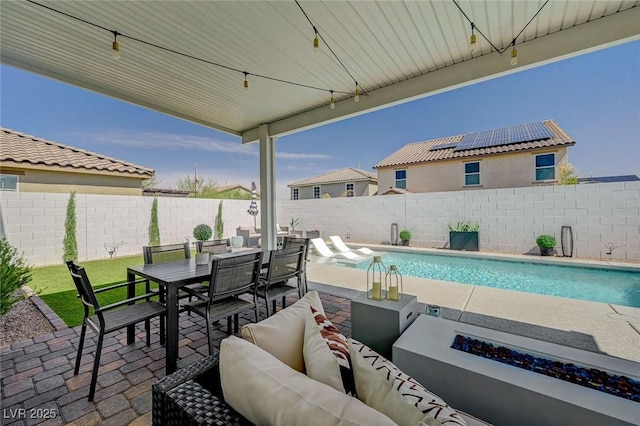2940 Duverney Ave, Henderson, NV 89044 - fenced backyard with an outdoor living space with a fire pit, a patio area, and outdoor dining space