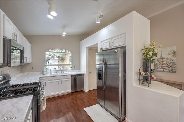 5687 Harbour Pointe Ave, Las Vegas, NV 89122 - kitchen with appliances with stainless steel finishes, white cabinetry, dark wood-style flooring, and light stone countertops