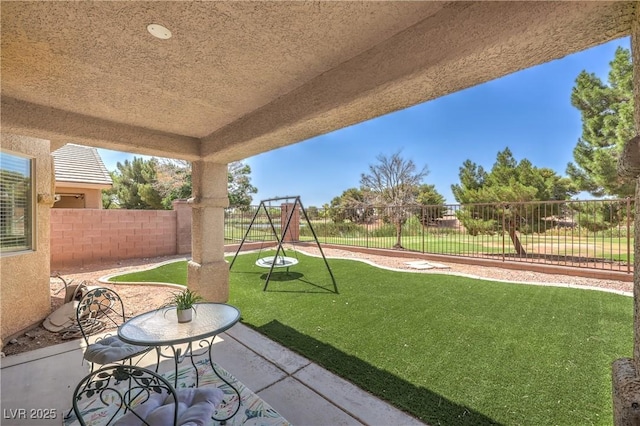 5687 Harbour Pointe Ave, Las Vegas, NV 89122 - fenced backyard with a playground and a patio area