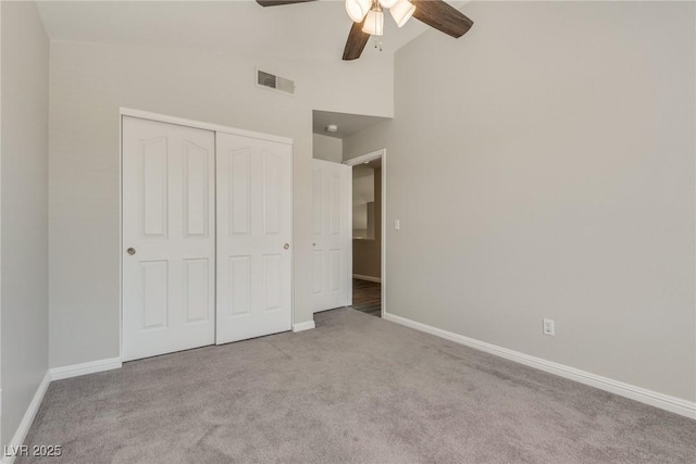7816 Calico Flower Ave, Las Vegas, NV 89128 - unfurnished bedroom featuring carpet floors, a closet, a ceiling fan, and high vaulted ceiling