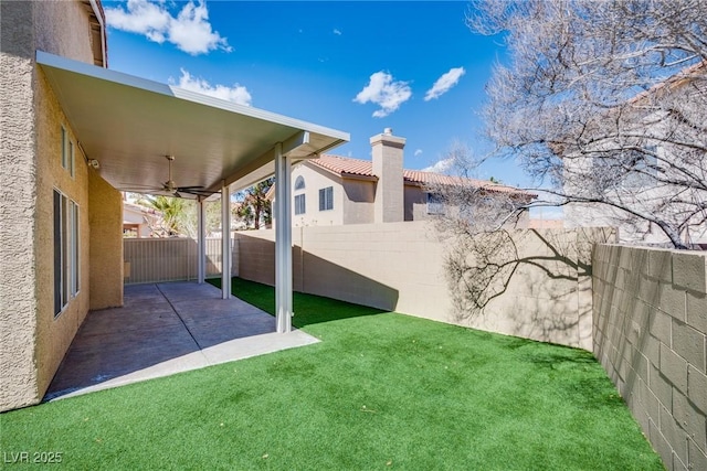 7816 Calico Flower Ave, Las Vegas, NV 89128 - fenced backyard featuring a ceiling fan and a patio area