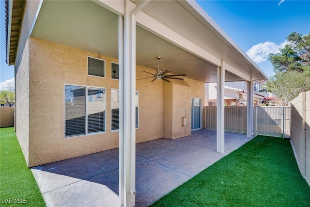7816 Calico Flower Ave, Las Vegas, NV 89128 - fenced backyard with a ceiling fan and a patio