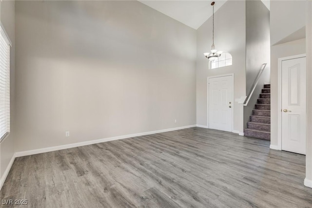 7816 Calico Flower Ave, Las Vegas, NV 89128 - foyer entrance with a chandelier, high vaulted ceiling, wood finished floors, and stairs