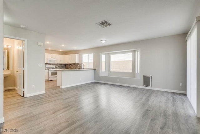 7816 Calico Flower Ave, Las Vegas, NV 89128 - unfurnished living room featuring light wood finished floors and recessed lighting