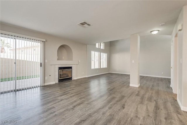 7816 Calico Flower Ave, Las Vegas, NV 89128 - unfurnished living room featuring wood finished floors and a fireplace