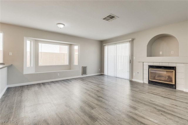7816 Calico Flower Ave, Las Vegas, NV 89128 - unfurnished living room with wood finished floors and a tile fireplace