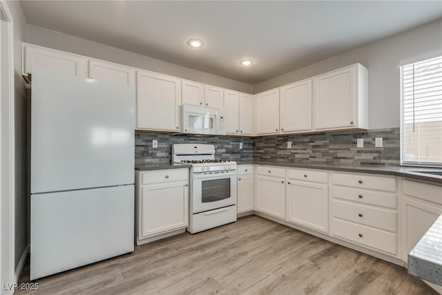 7816 Calico Flower Ave, Las Vegas, NV 89128 - kitchen with white appliances, dark countertops, white cabinetry, backsplash, and recessed lighting