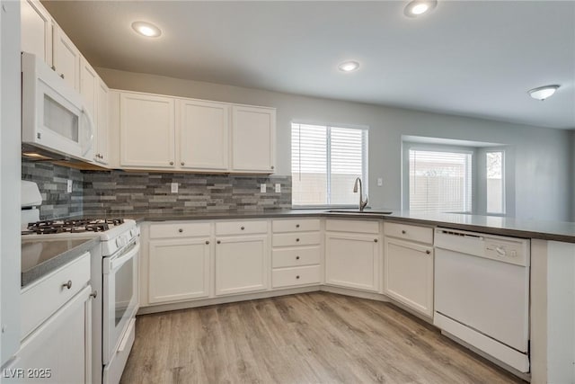 7816 Calico Flower Ave, Las Vegas, NV 89128 - kitchen featuring white appliances, tasteful backsplash, dark countertops, light wood finished floors, and recessed lighting