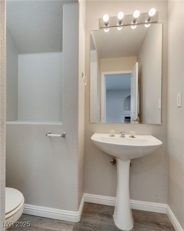 7816 Calico Flower Ave, Las Vegas, NV 89128 - half bathroom with toilet and wood finished floors