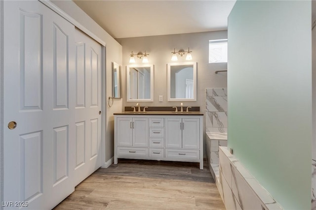 7816 Calico Flower Ave, Las Vegas, NV 89128 - full bathroom featuring double vanity, wood finished floors, and a tub to relax in