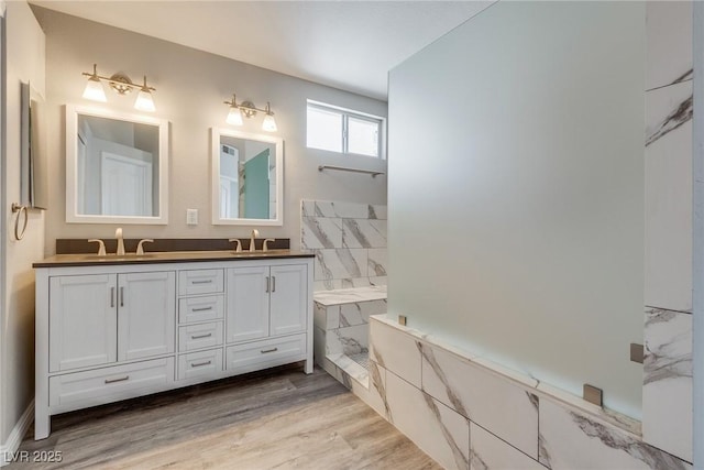7816 Calico Flower Ave, Las Vegas, NV 89128 - bathroom featuring double vanity, a marble finish shower, and wood finished floors