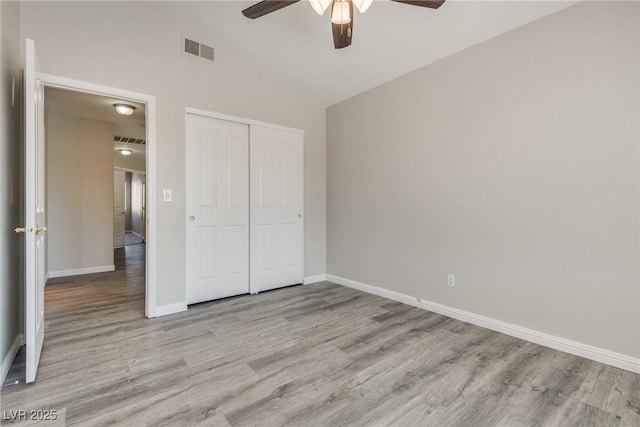 7816 Calico Flower Ave, Las Vegas, NV 89128 - unfurnished bedroom with wood finished floors, lofted ceiling, a closet, and ceiling fan