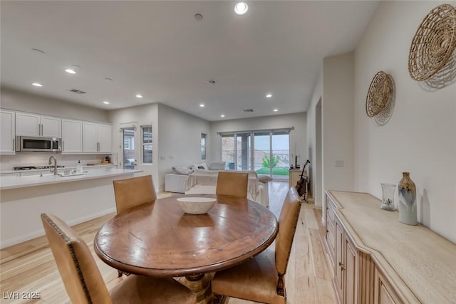 32 Tatahatso Point St, Henderson, NV 89011 - dining room featuring light wood-style flooring and recessed lighting