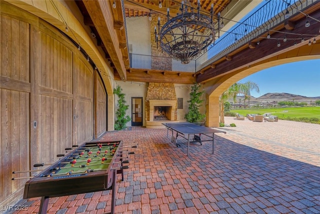 32 Tatahatso Point St, Henderson, NV 89011 - view of patio featuring an outdoor stone fireplace and a mountain view