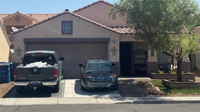 422 Rancho Del Norte Dr, North Las Vegas, NV 89031 - view of front of house featuring a tiled roof, a garage, driveway, and stucco siding