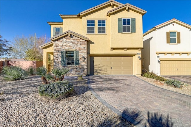 8992 Sparkling River Ct, Las Vegas, NV 89178 - view of front facade with stucco siding, stone siding, an attached garage, decorative driveway, and a tile roof
