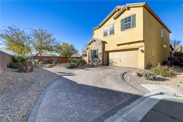 8992 Sparkling River Ct, Las Vegas, NV 89178 - view of side of property with stucco siding, a garage, a fenced backyard, and decorative driveway