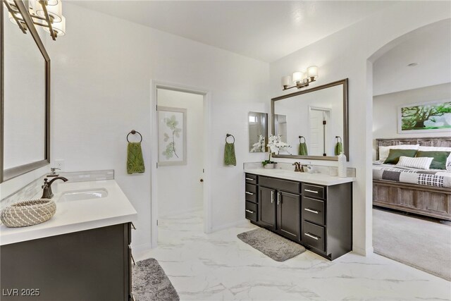 8992 Sparkling River Ct, Las Vegas, NV 89178 - full bath featuring two vanities, marble look tiles, and ensuite bath