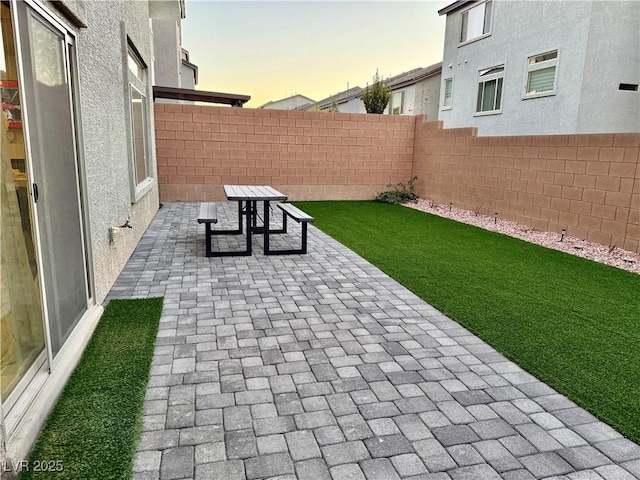 10411 Rose Palisade St, Las Vegas, NV 89141 - patio terrace at dusk featuring a fenced backyard and a patio area