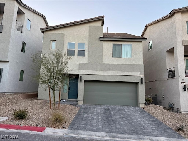 10411 Rose Palisade St, Las Vegas, NV 89141 - view of front of property with stucco siding, decorative driveway, and a garage