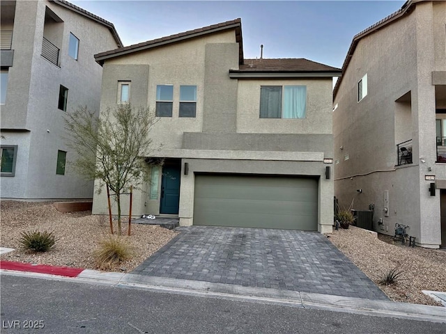 10411 Rose Palisade St, Las Vegas, NV 89141 - view of front facade featuring stucco siding, a garage, and decorative driveway