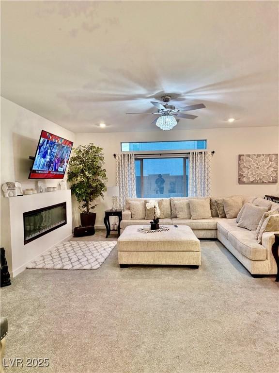 10411 Rose Palisade St, Las Vegas, NV 89141 - living area with a glass covered fireplace, carpet, a ceiling fan, and recessed lighting