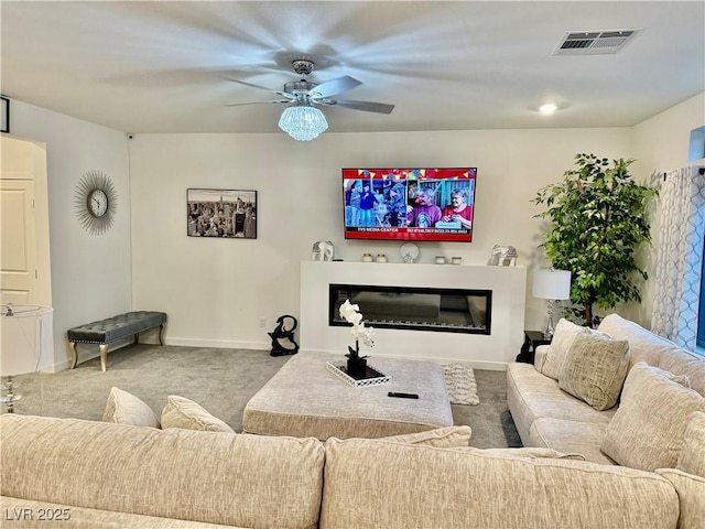 10411 Rose Palisade St, Las Vegas, NV 89141 - carpeted living room featuring a ceiling fan and a glass covered fireplace