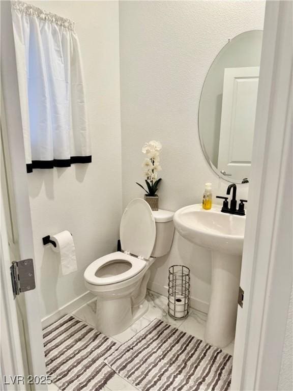 10411 Rose Palisade St, Las Vegas, NV 89141 - bathroom with baseboards and marble look tiles