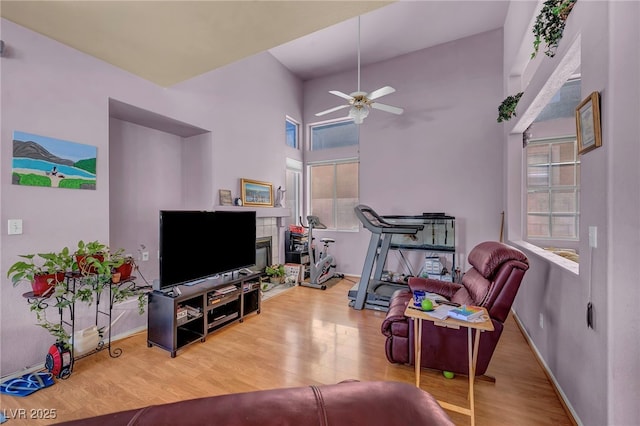2180 Polynesia Cir, Henderson, NV 89074 - living area featuring wood finished floors, ceiling fan, plenty of natural light, and a high ceiling