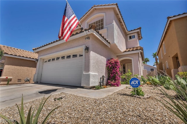 2180 Polynesia Cir, Henderson, NV 89074 - mediterranean / spanish home featuring a tile roof, stucco siding, concrete driveway, and a garage