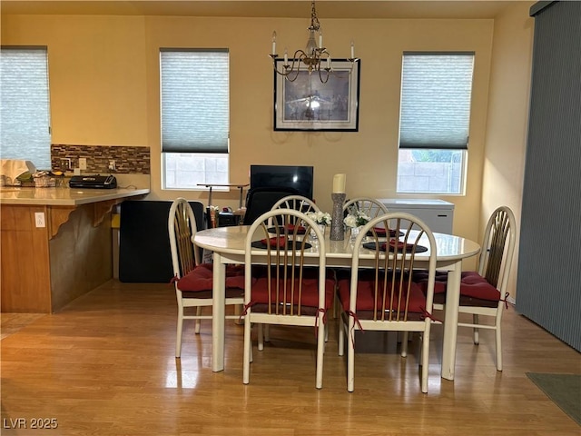 2180 Polynesia Cir, Henderson, NV 89074 - dining area featuring light wood-style flooring and a chandelier