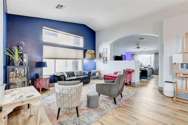 8926 Termoli St, Las Vegas, NV 89123 - living room with arched walkways, wood finished floors, a ceiling fan, and lofted ceiling
