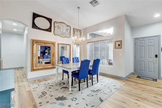 8926 Termoli St, Las Vegas, NV 89123 - dining area with arched walkways, a chandelier, wood finished floors, lofted ceiling, and recessed lighting