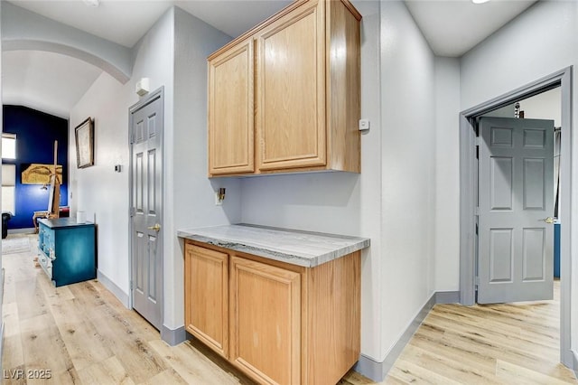 8926 Termoli St, Las Vegas, NV 89123 - hall featuring light wood-type flooring, arched walkways, and vaulted ceiling