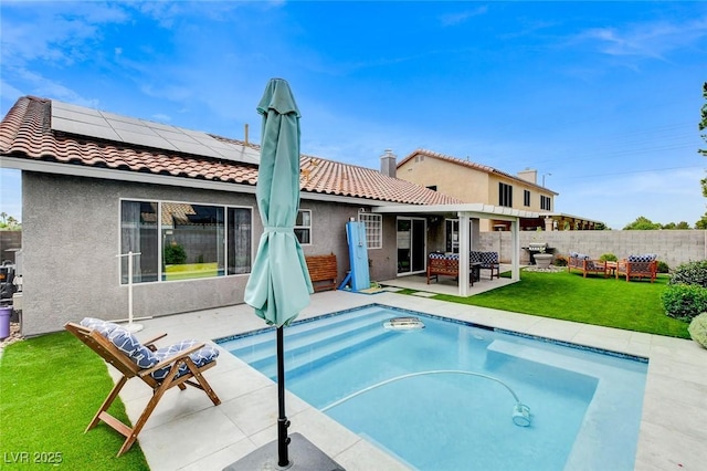 8926 Termoli St, Las Vegas, NV 89123 - rear view of house with a tiled roof, solar panels, an outdoor hangout area, and stucco siding