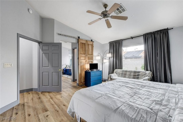 8926 Termoli St, Las Vegas, NV 89123 - bedroom with lofted ceiling, a barn door, light wood finished floors, and ceiling fan
