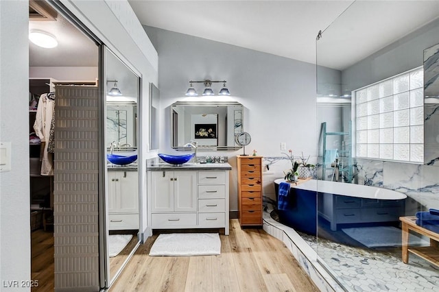 8926 Termoli St, Las Vegas, NV 89123 - bathroom featuring wood finished floors, a freestanding tub, and vanity